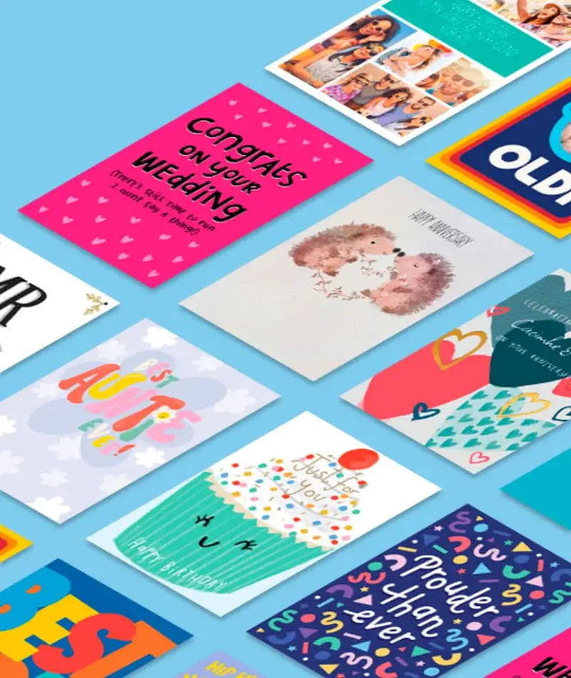 Colorful greeting cards arranged on a light blue background, featuring various designs, patterns, and celebratory messages.